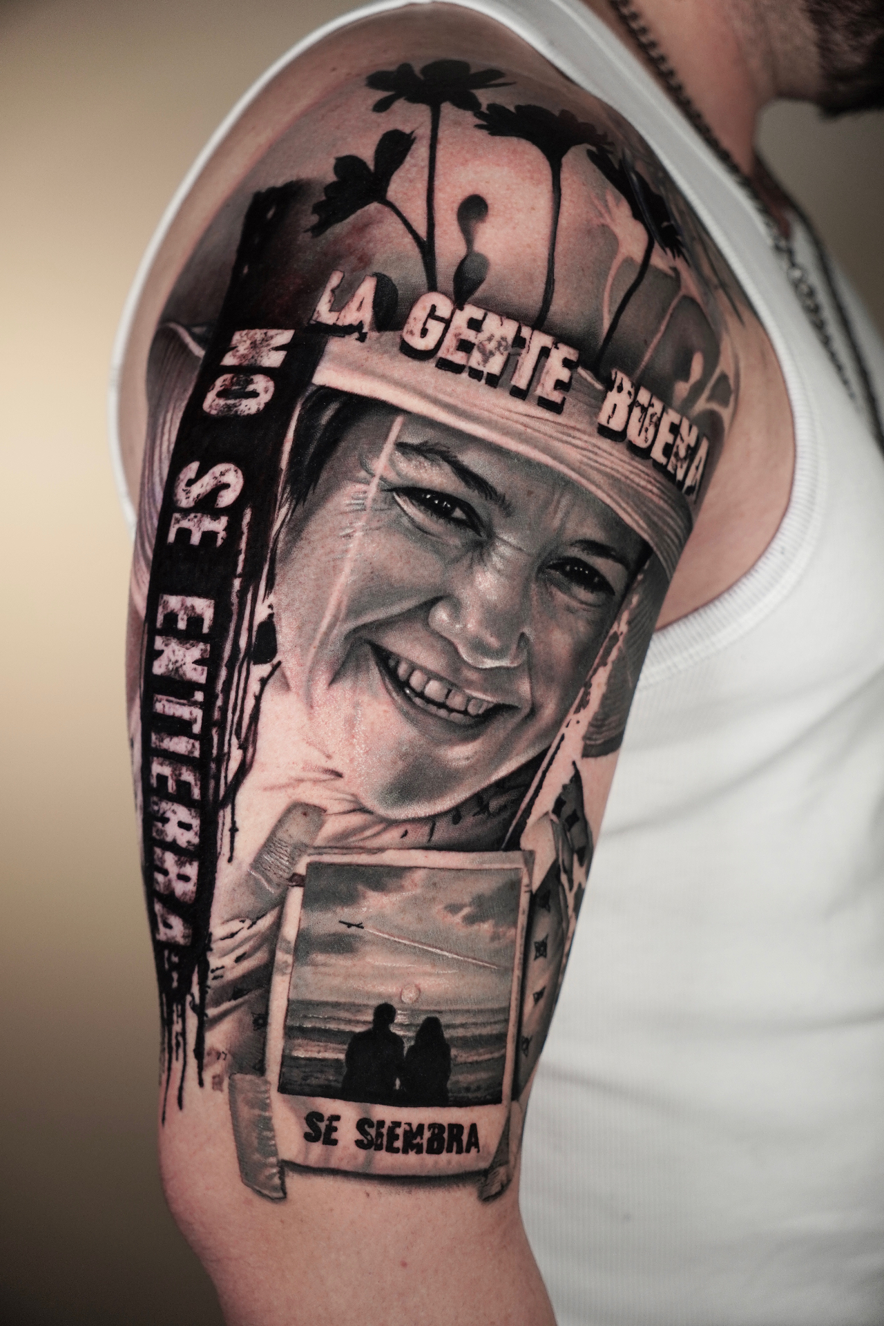 Black and grey realism portrait sleeve with 'La Gente Buena No Se Entierra Se Siembra' lettering by Yeins Gomez