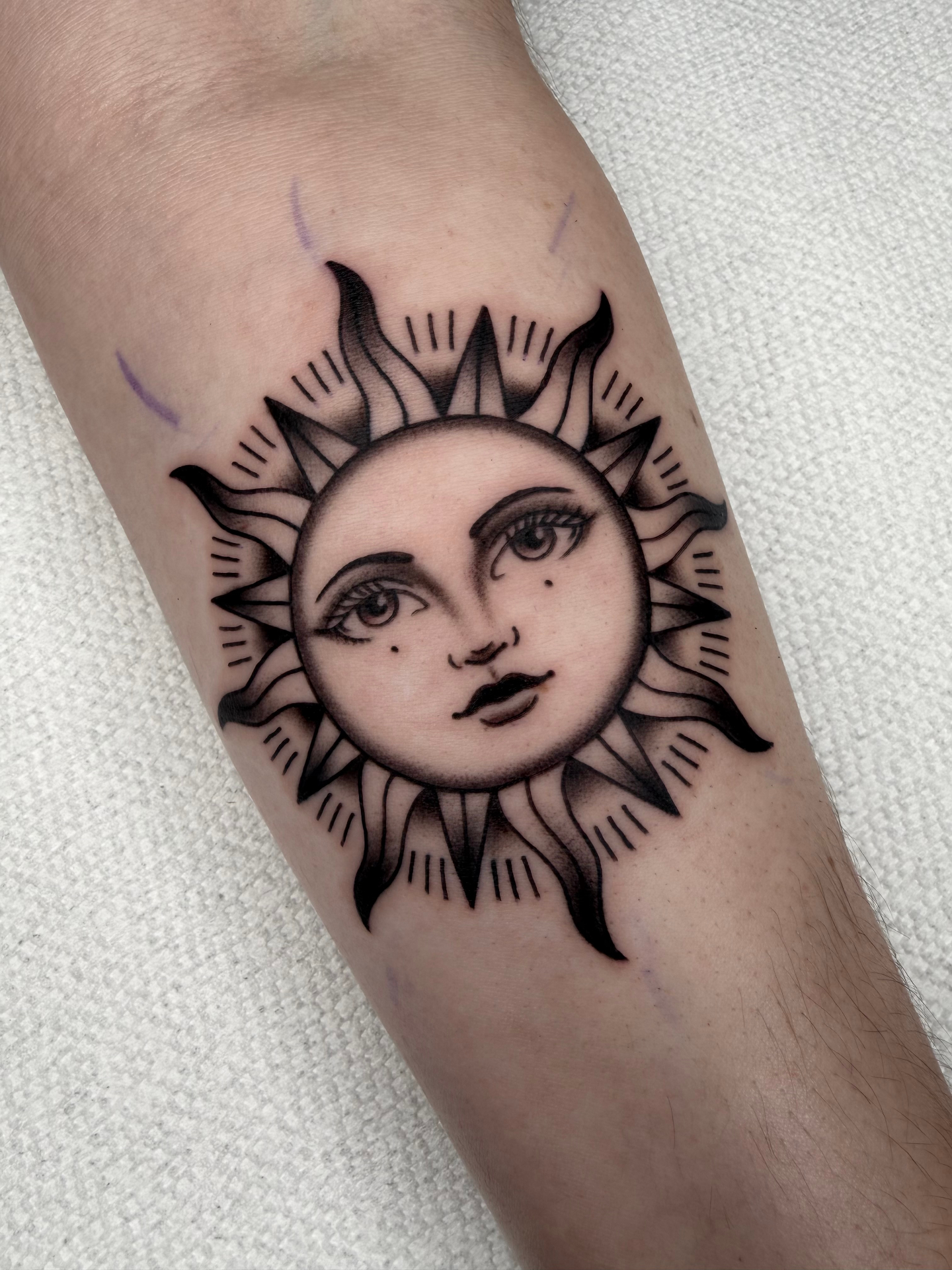Black and grey sun face tattoo by Matt Maldonado