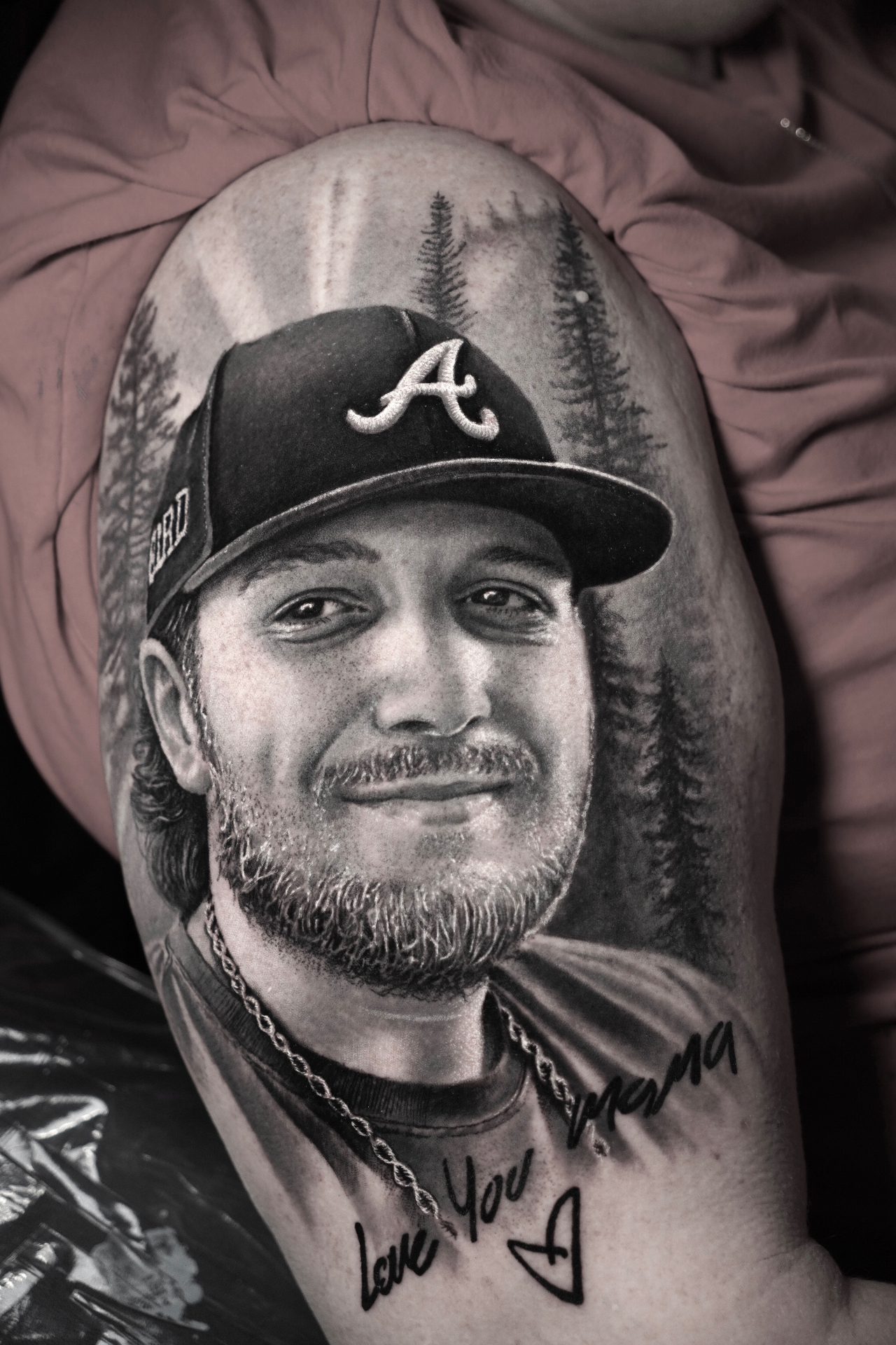 Black and grey realism portrait of a man in an Atlanta Braves cap with forest background by Yeins Gomez