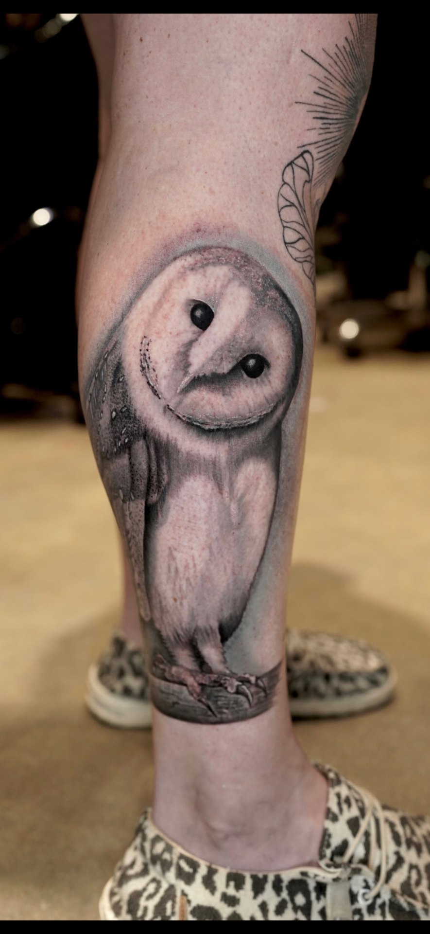 Black and grey realism barn owl calf tattoo by Kent Harrison