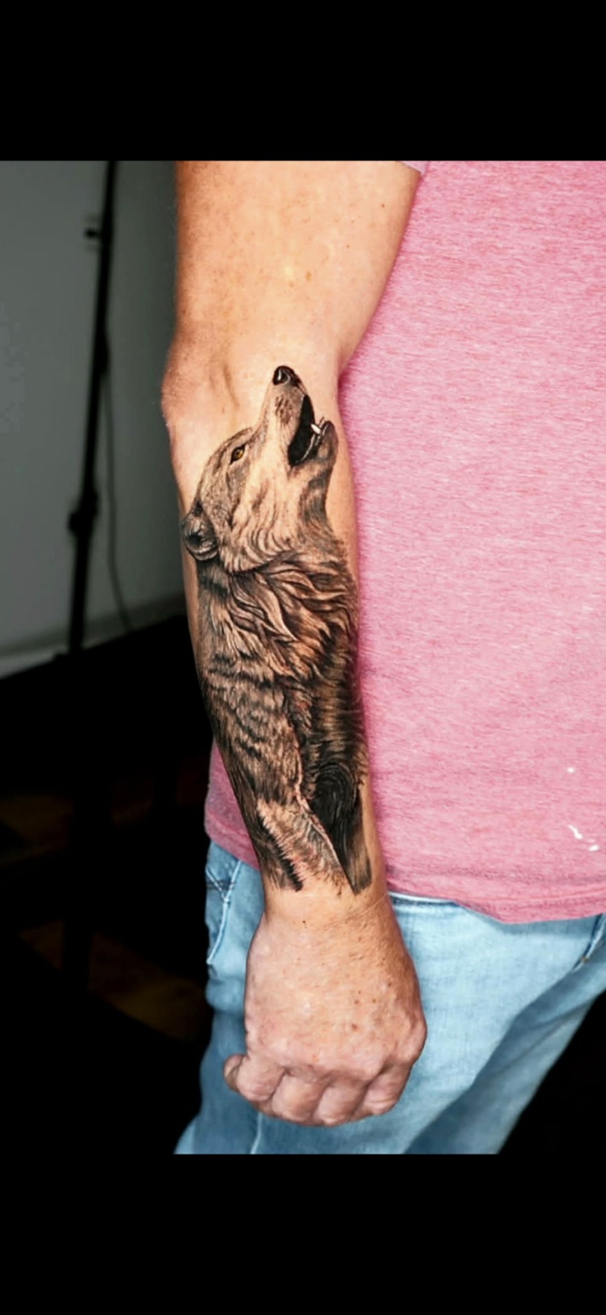 Black and grey realism howling wolf forearm tattoo by Kent Harrison